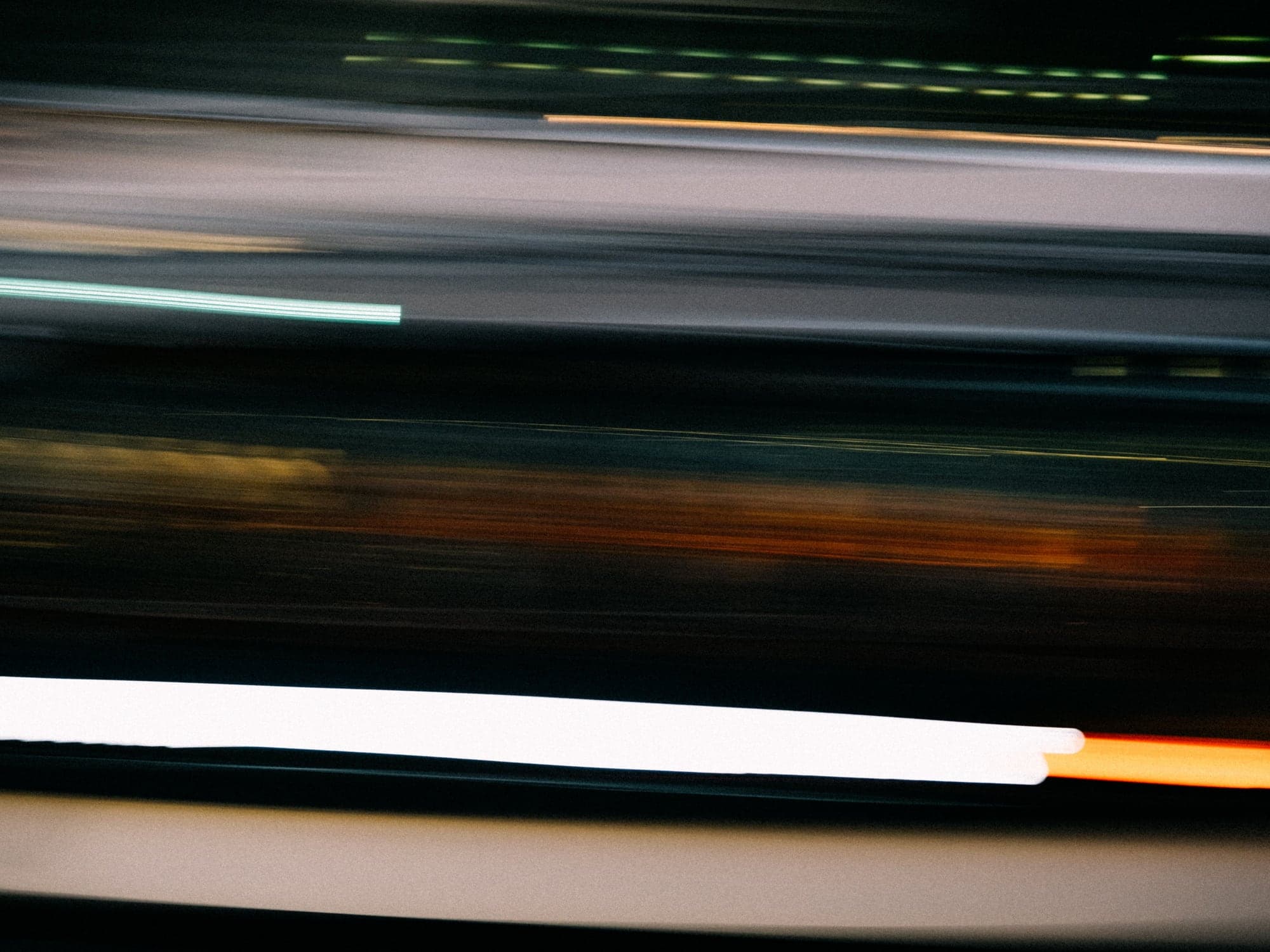 Streaks of light drawn into long horizontal lines by a slow exposure.
